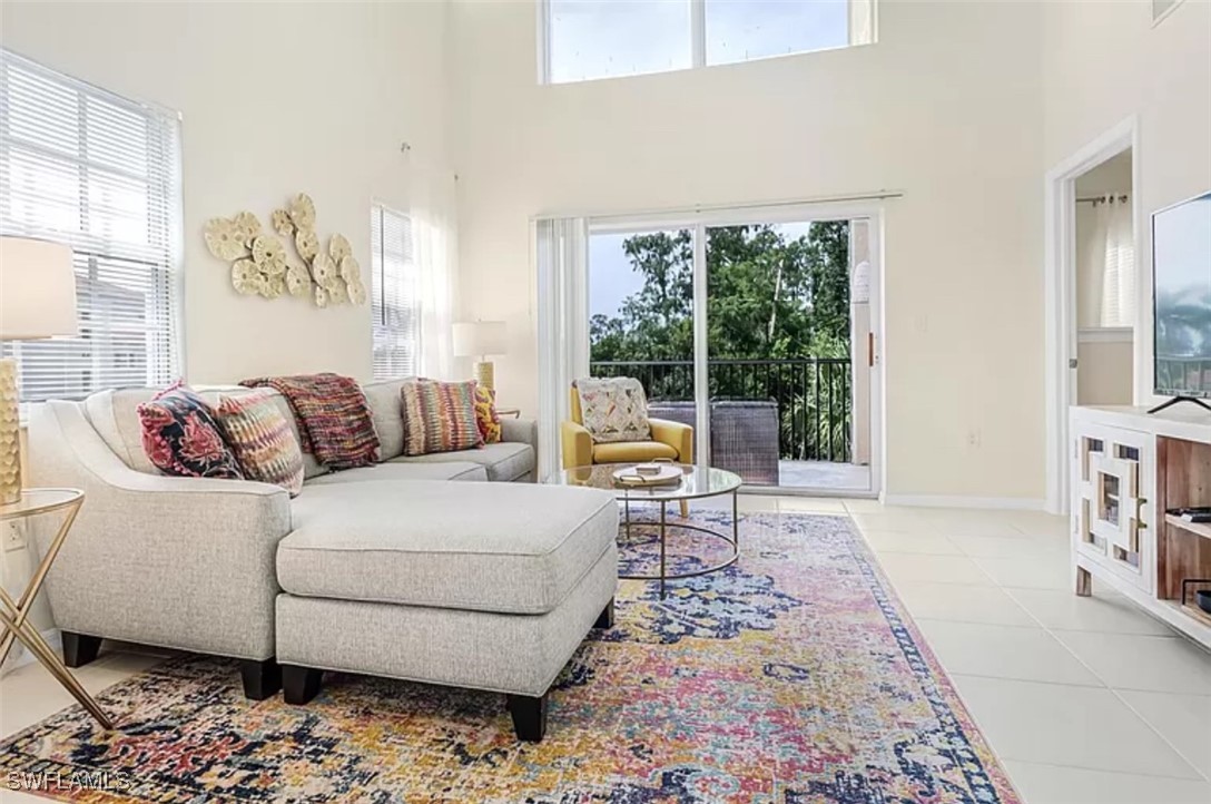 4450 Botanical Pl Circle, Unit 6 Naples, FL 34112 - Photo 23 of 33 a living room with furniture and a large window