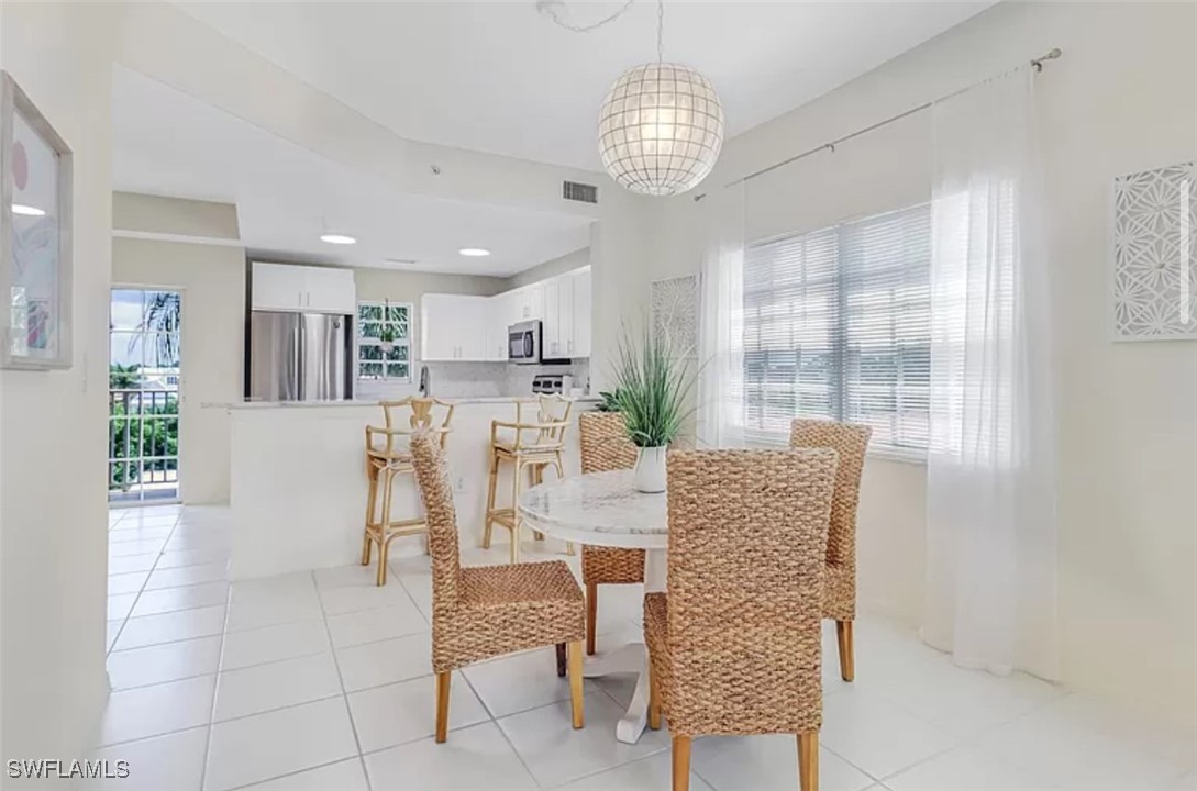 4450 Botanical Pl Circle, Unit 6 Naples, FL 34112 - Photo 24 of 33 a view of a dining room with furniture