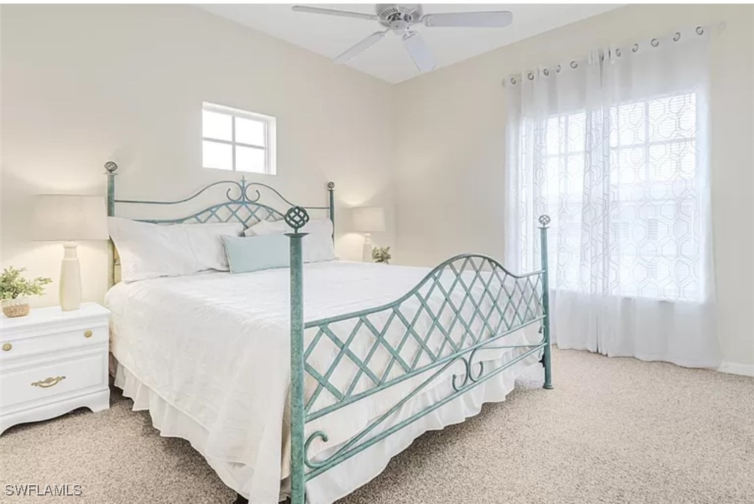 4450 Botanical Pl Circle, Unit 6 Naples, FL 34112 - Photo 10 of 33 a bed sitting in a bedroom next to a window