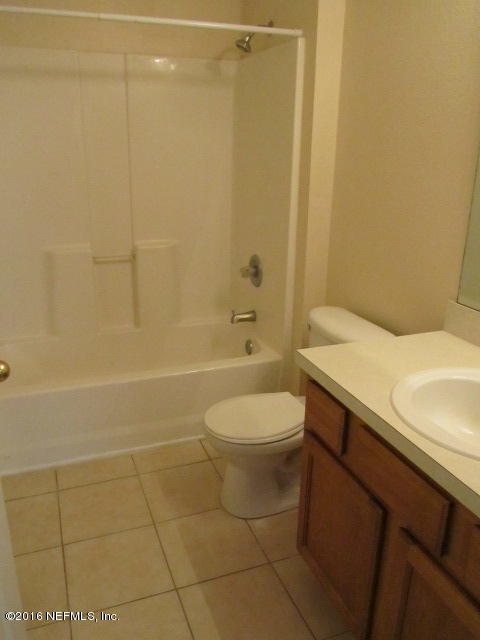 7920 Merrill Road, Unit 2016 Jacksonville, FL 32277 - Photo 8 of 17 a bathroom with a sink a toilet and shower