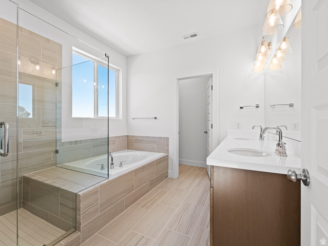 18 South Crimson Way, Unit 304 Mapleton, UT 84664 - Photo 17 of 17 Bathroom featuring double vanity, a bath, and a shower stall