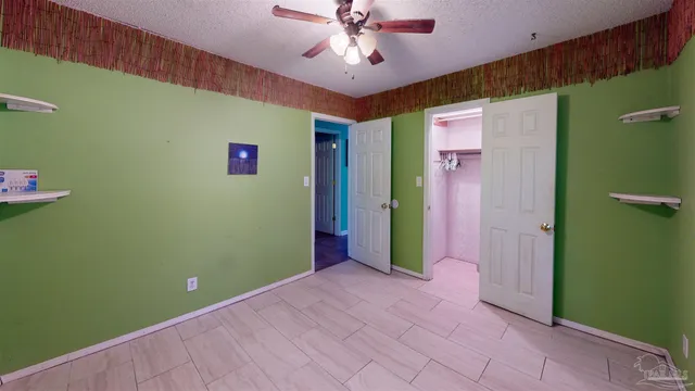 a view of livingroom with an empty space and a ceiling fan