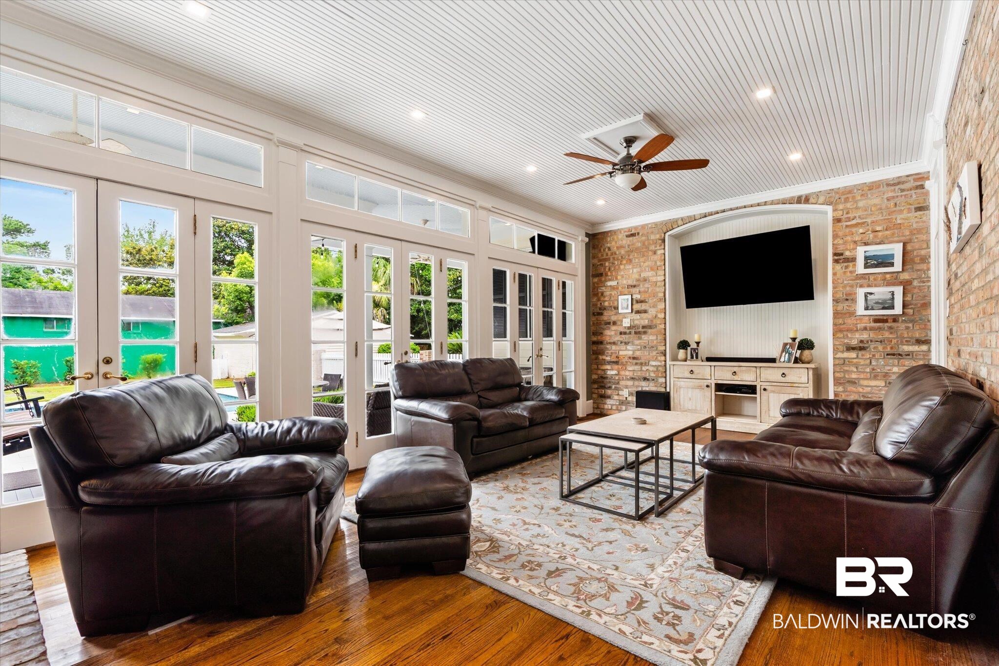 2205 Spring Hill Avenue Mobile, AL 36607 - Photo 21 of 59 Living room with hardwood / wood-style flooring, french doors, brick wall, and ornamental molding