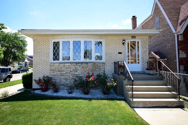 7301 West Roscoe Street Chicago, IL 60634 - Photo 1 of 22 a front view of house with yard