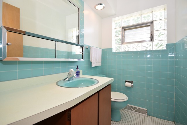 7301 West Roscoe Street Chicago, IL 60634 - Photo 16 of 22 a bathroom with a sink a toilet and a mirror