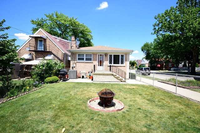 7301 West Roscoe Street Chicago, IL 60634 - Photo 21 of 22 a house view with a garden space