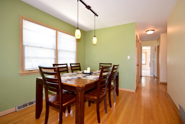 7301 West Roscoe Street Chicago, IL 60634 - Photo 5 of 22 a view of a dining room with furniture and wooden floor