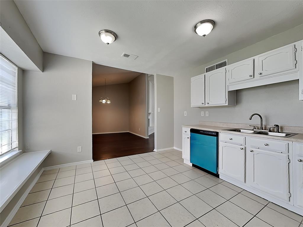 7621 Pebble Beach Drive Rowlett, TX 75088 - Photo 6 of 20 a view of a kitchen with white cabinets