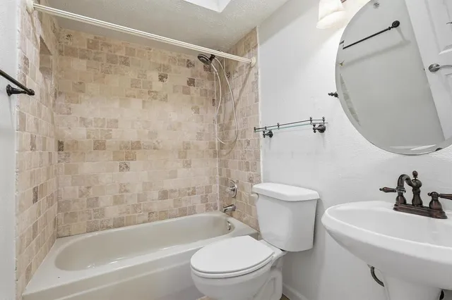 a bathroom with a toilet a sink and a bathtub