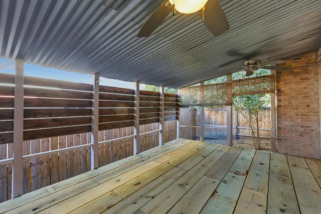 a view of empty room with wooden floor and windows