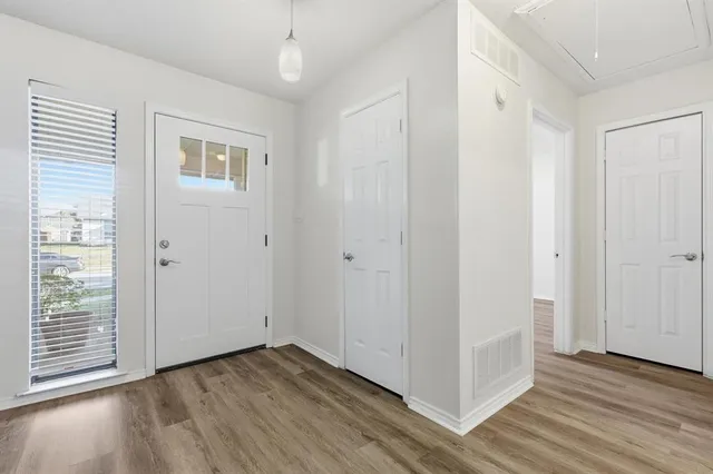 a view of a livingroom with wooden floor and a window
