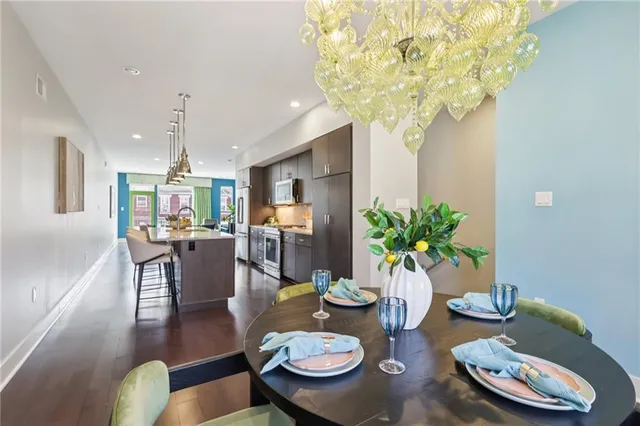 a view of a dining room with furniture and chandelier