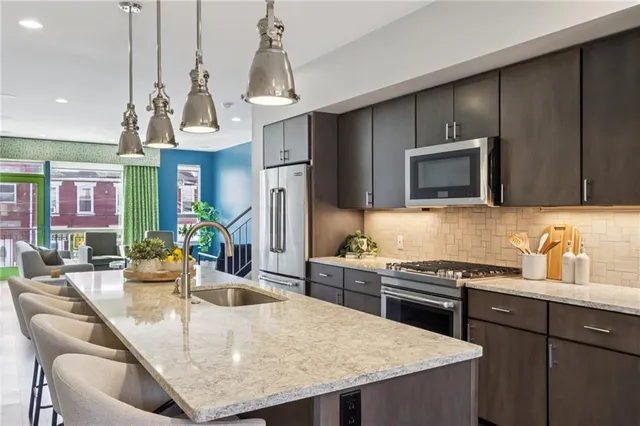 a kitchen with sink cabinets and microwave