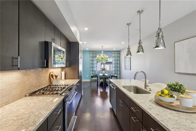 a kitchen with sink stove and cabinets