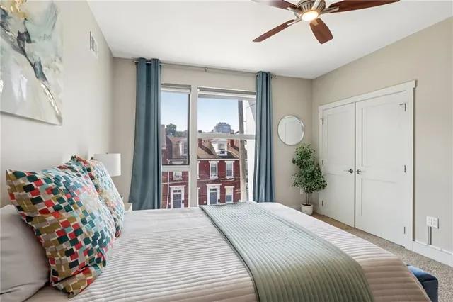 a bedroom with a bed and a chandelier