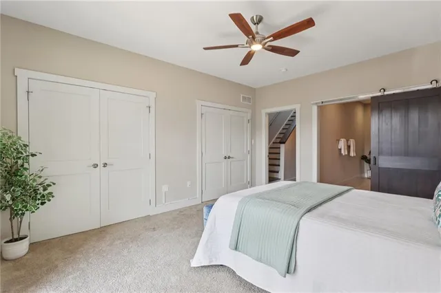 a bedroom with a large bed and potted plant