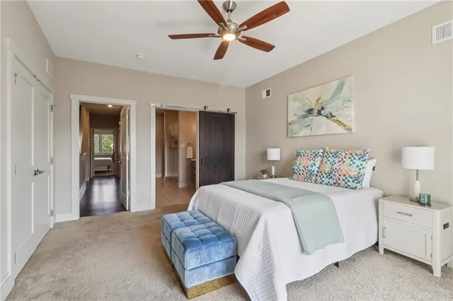 a bedroom with a large bed and a chandelier
