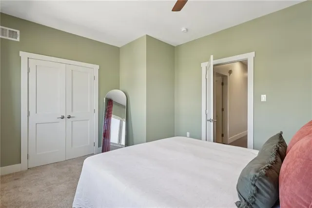 a bedroom with a bed and a mirror