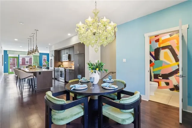 a view of a dining room with furniture wooden floor and chandelier