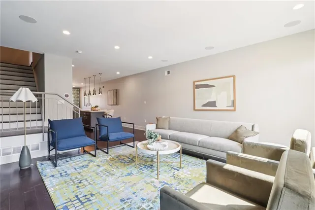 a living room with furniture and a wooden floor