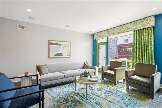 a living room with furniture and a large window