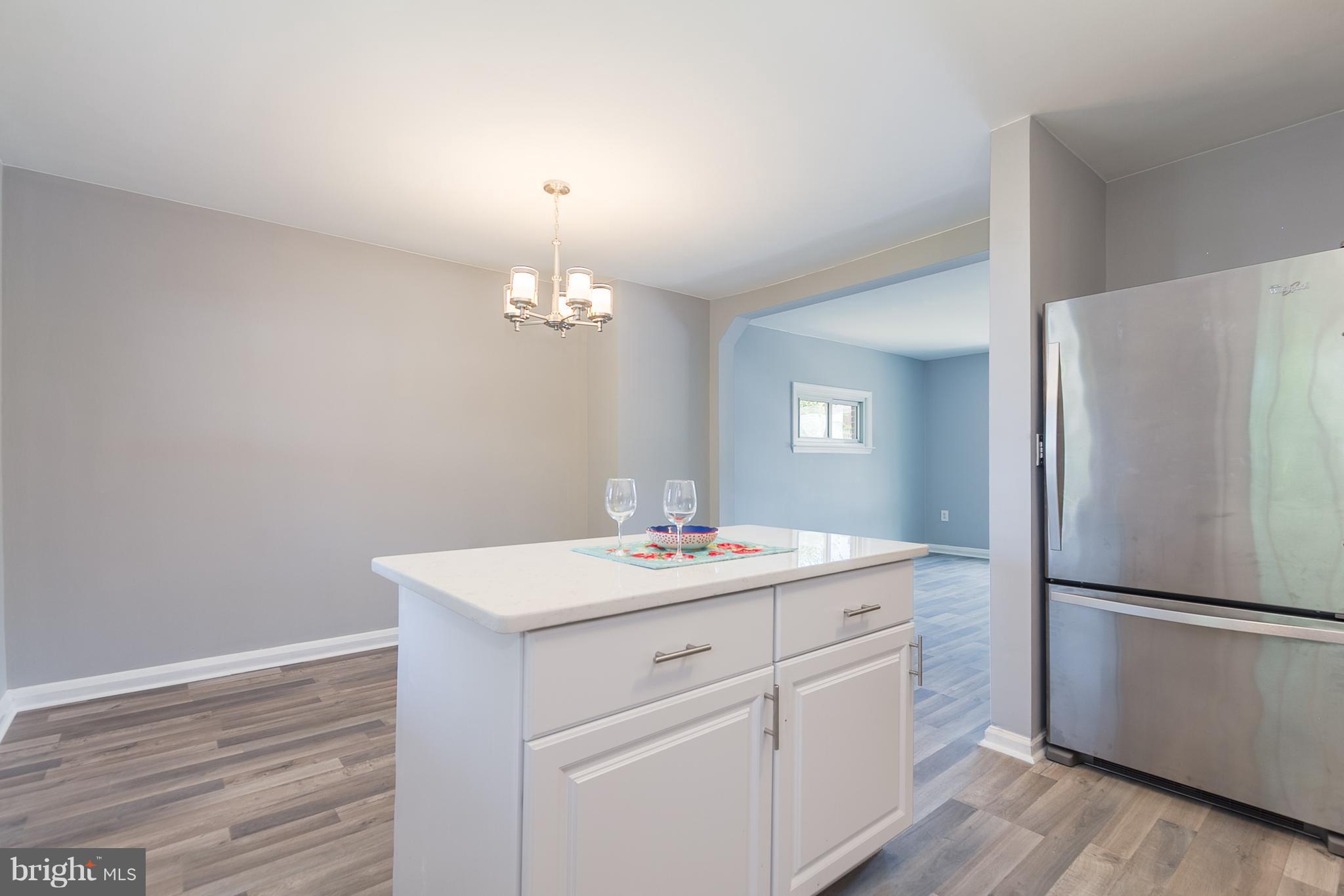 2806 Kirkleigh Road Baltimore, MD 21222 - Photo 3 of 10 a kitchen with a sink cabinets and wooden floor