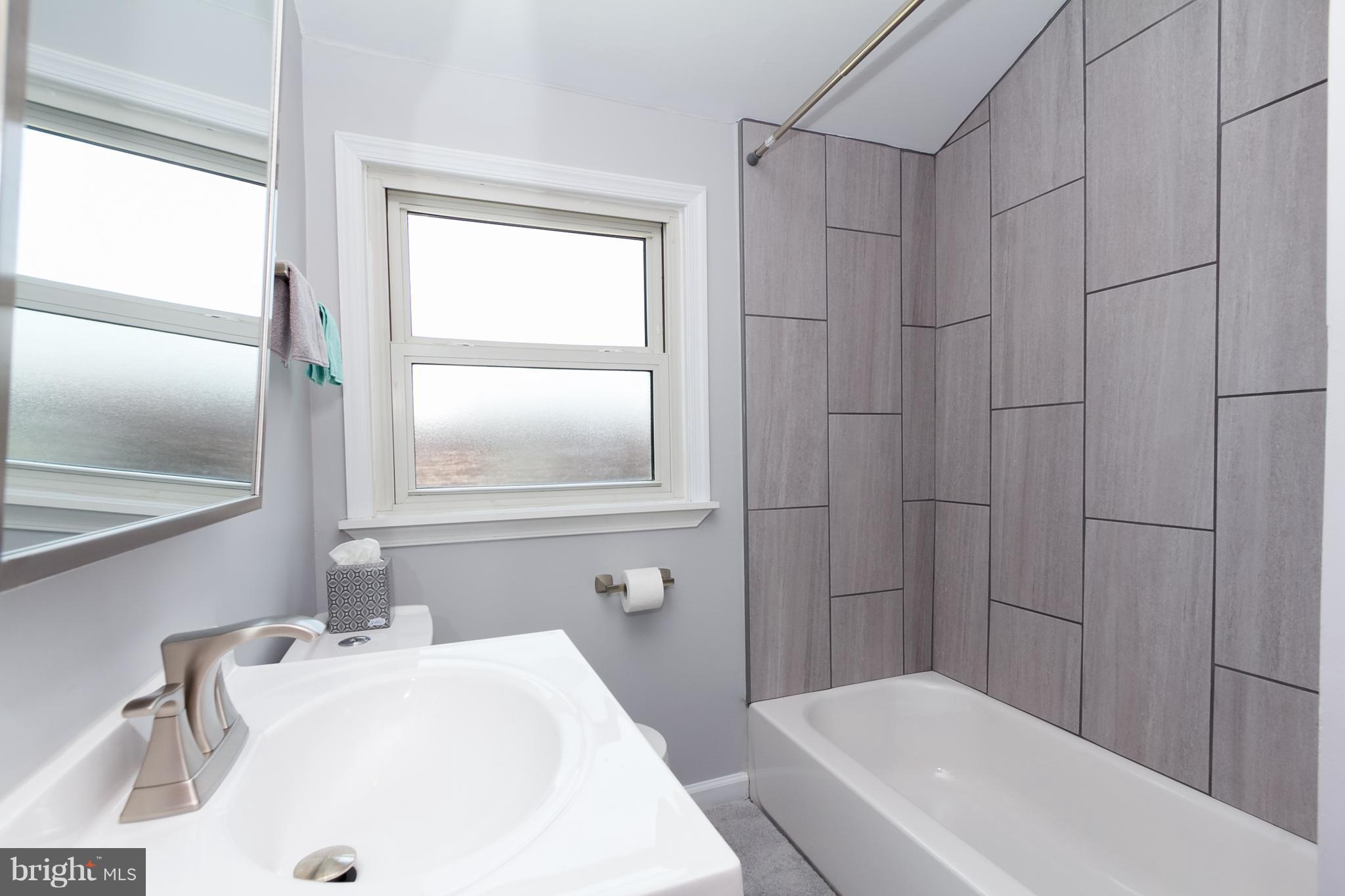 2806 Kirkleigh Road Baltimore, MD 21222 - Photo 4 of 10 a bathroom with a sink a toilet and shower