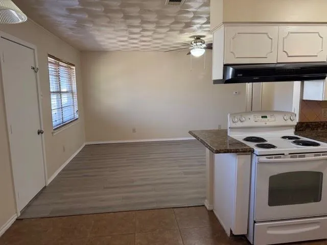 a kitchen with granite countertop cabinets stainless steel appliances and a sink