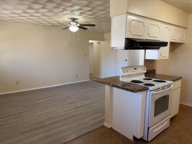 a stove top oven sitting inside of a kitchen