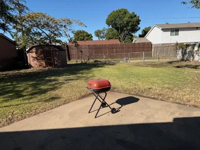 a backyard of a house with table and chairs