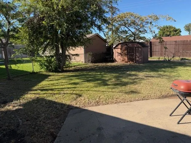 a view of a house with pool yard and a tree