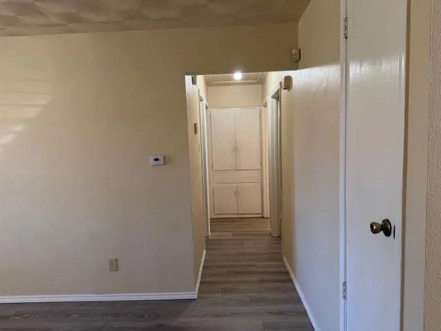 a view of a hallway with wooden floor