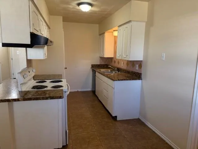 a kitchen with a stove and a microwave