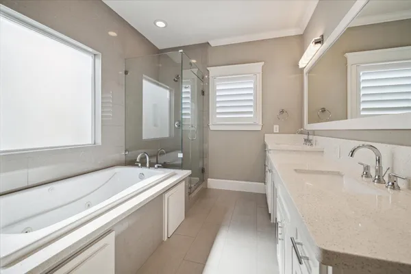a bathroom with a tub sink and mirror