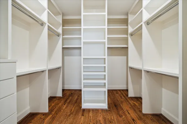 a view of walk in closet with empty racks