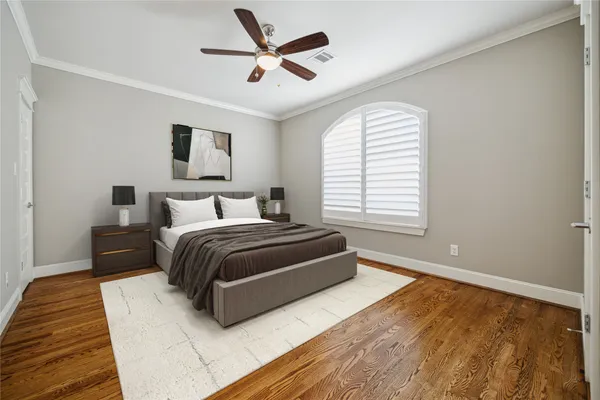 a bedroom with a large bed and a ceiling fan