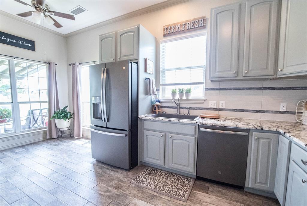 10336 Jennifer Circle Forney, TX 75126 - Photo 12 of 37 Here at the end of the kitchen is a separate breakfast area with many windows offering great view to the rear of the large covered porch and yard.