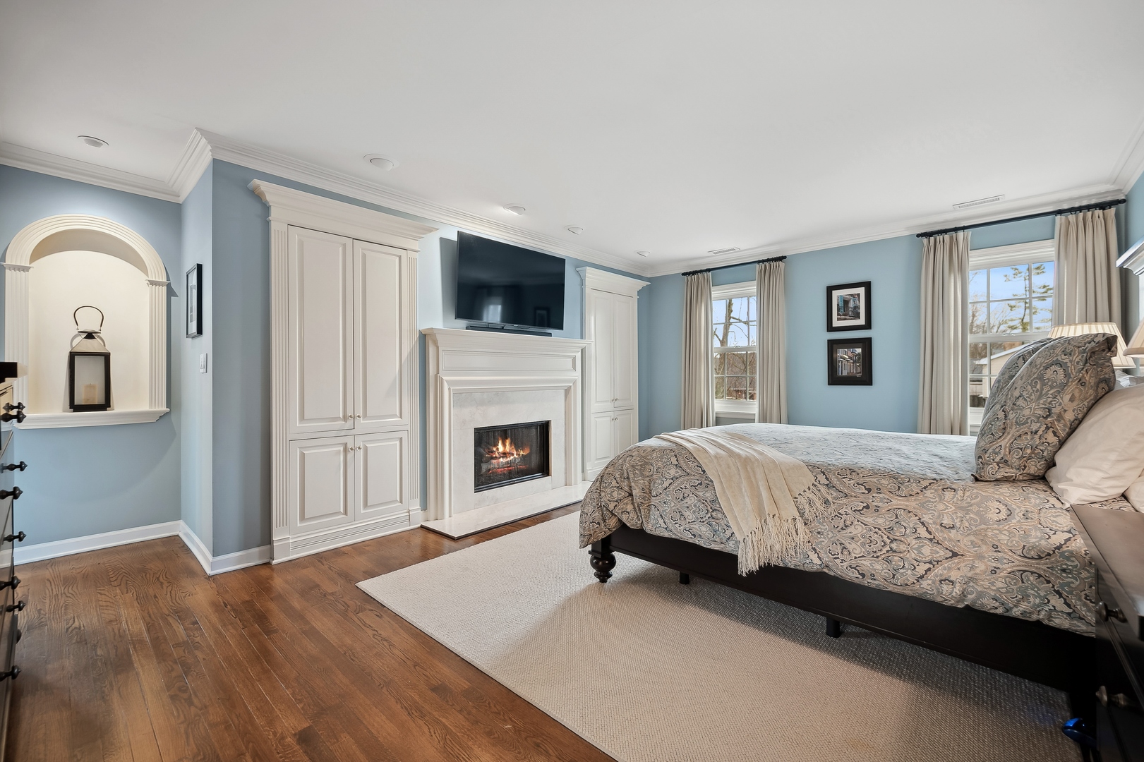 2002 Brandon Road Glenview, IL 60025 - Photo 17 of 37 a spacious bedroom with a large bed and a fireplace