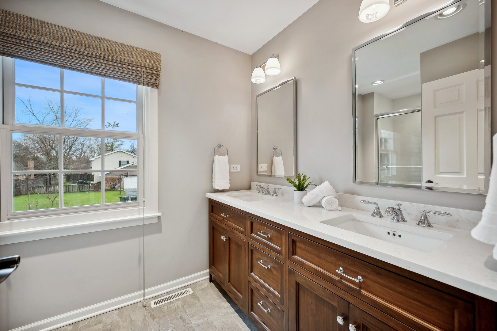 2002 Brandon Road Glenview, IL 60025 - Photo 26 of 37 a bathroom with a double vanity sink and a mirror