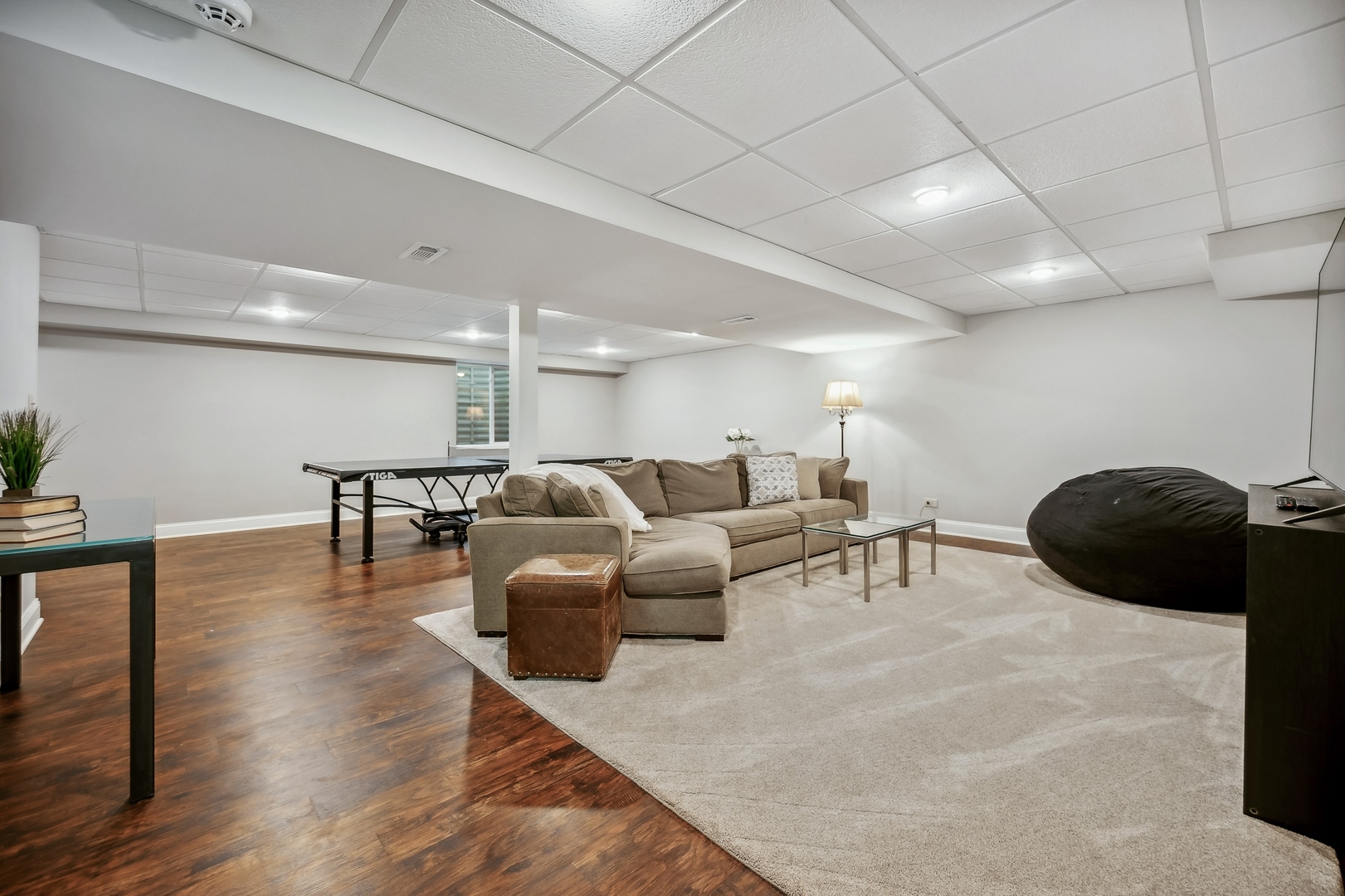 2002 Brandon Road Glenview, IL 60025 - Photo 27 of 37 a living room with furniture a wooden floor and kitchen chandelier