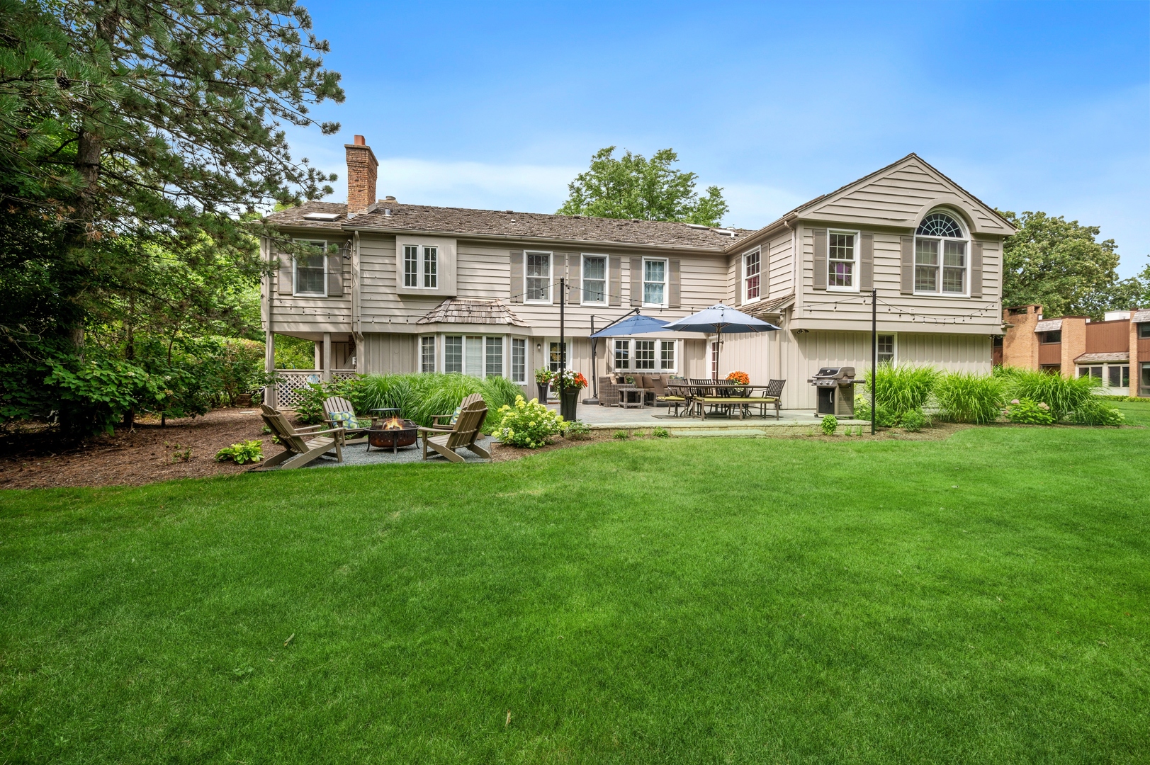 2002 Brandon Road Glenview, IL 60025 - Photo 31 of 37 a front view of a house with a yard table and chairs