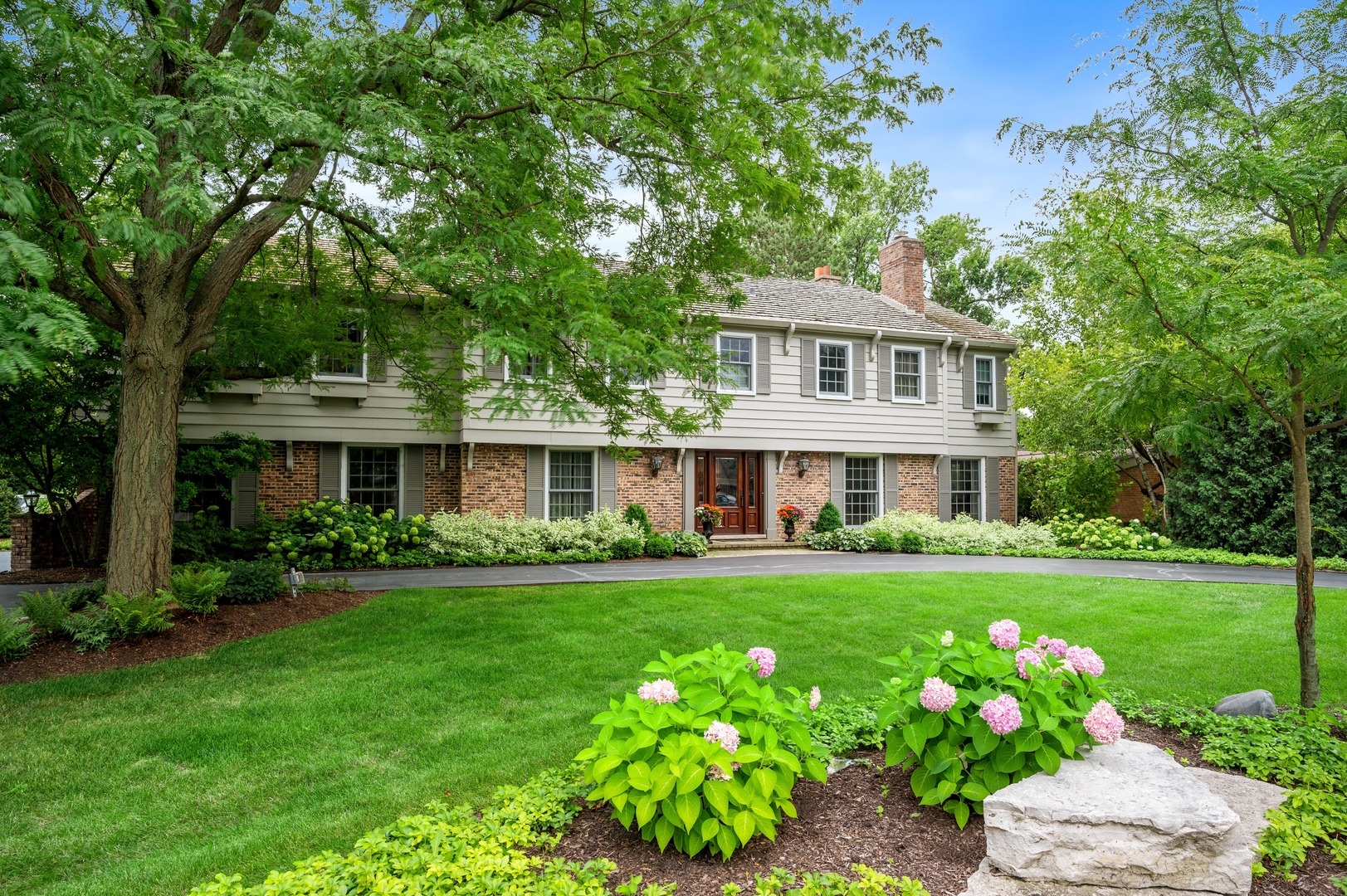 2002 Brandon Road Glenview, IL 60025 - Photo 34 of 37 a front view of a house with a garden