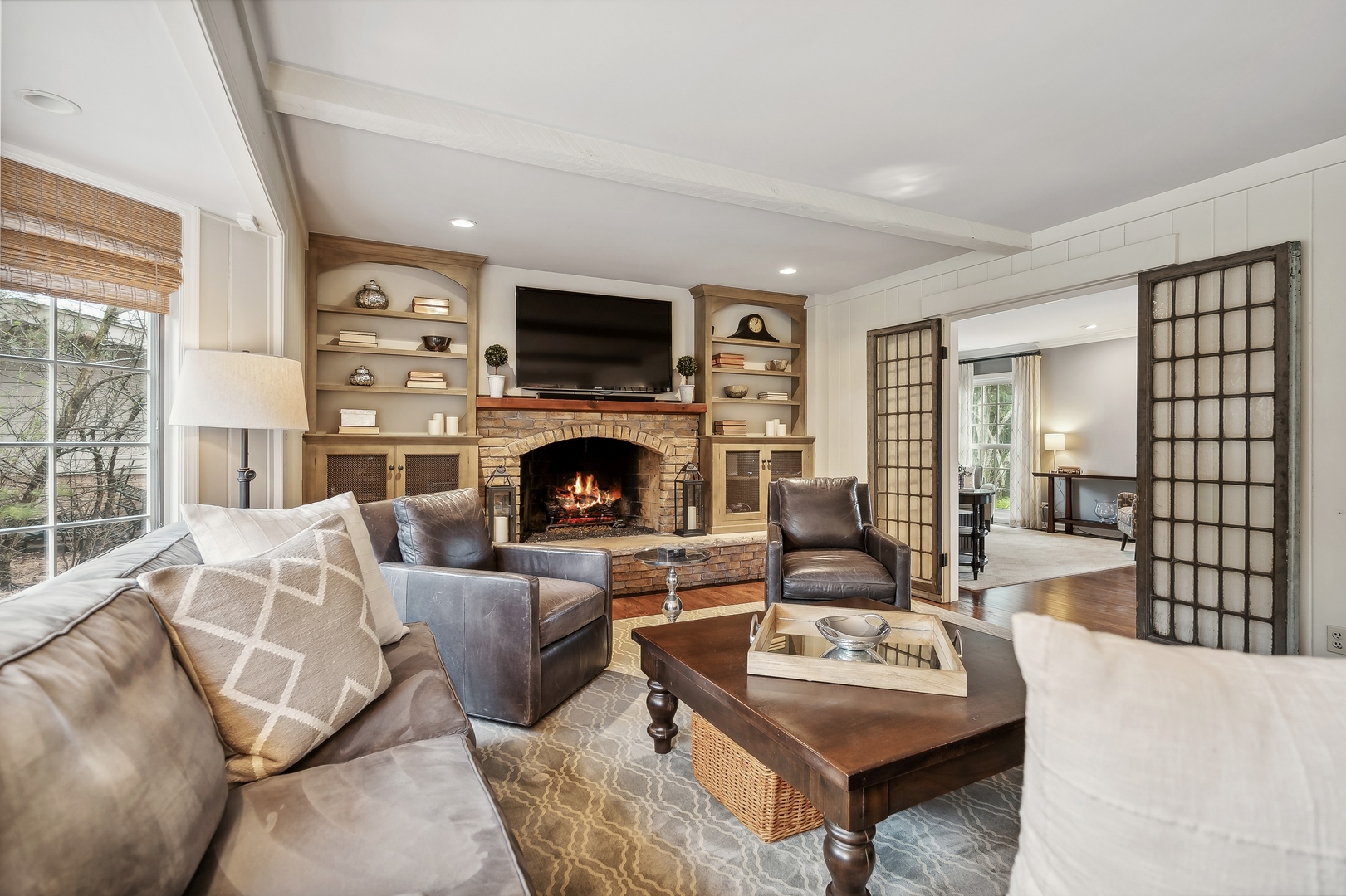 2002 Brandon Road Glenview, IL 60025 - Photo 7 of 37 a living room with furniture a fireplace and a flat screen tv
