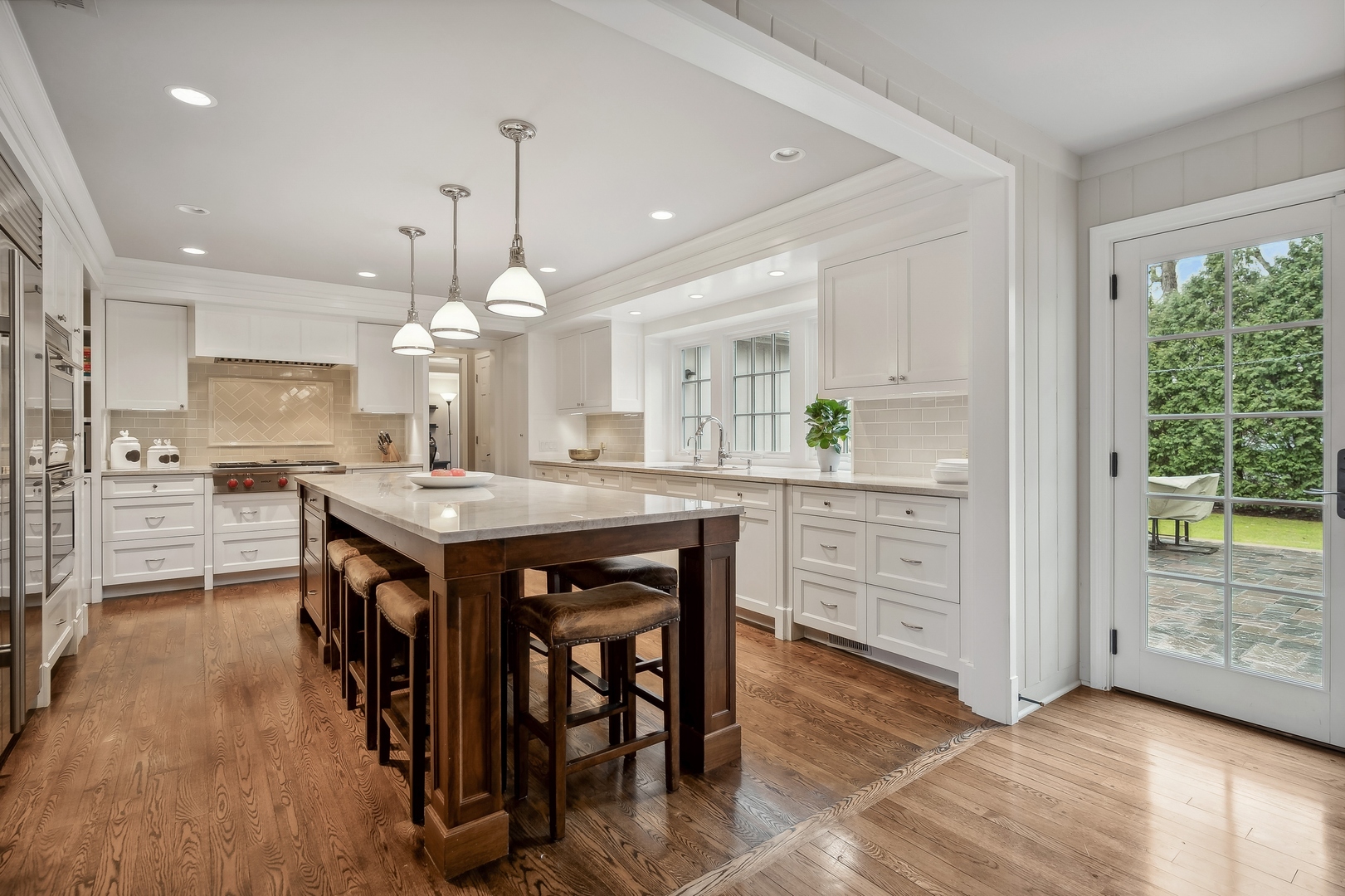 2002 Brandon Road Glenview, IL 60025 - Photo 10 of 37 a kitchen with stainless steel appliances kitchen island granite countertop a table chairs and a refrigerator