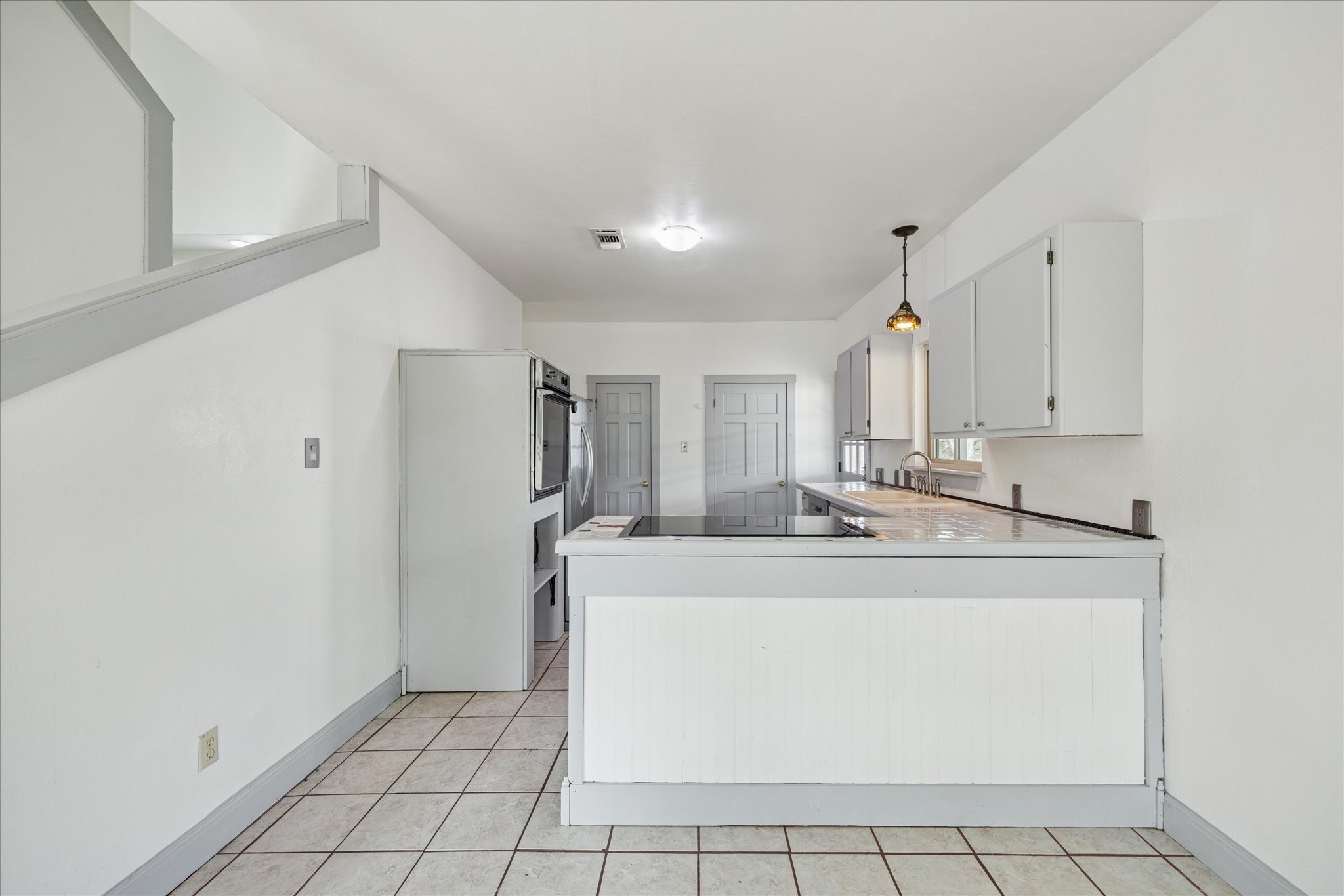 13918 Hummingbird Lane Austin, TX 78732 - Photo 11 of 32 a large white kitchen with a sink and dishwasher
