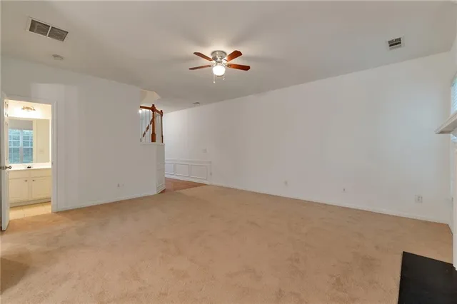 a view of a livingroom with a ceiling fan and window