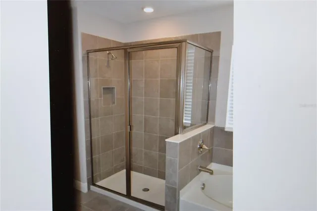 a bathroom with a glass shower door