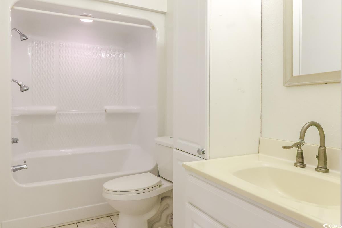 2191 Jasmine Road Loris, SC 29569 - Photo 13 of 40 Full bathroom with vanity, toilet, washtub / shower combination, and tile patterned floors