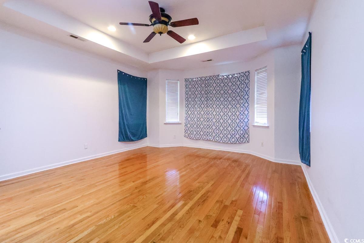 2191 Jasmine Road Loris, SC 29569 - Photo 14 of 40 Unfurnished room with a raised ceiling, a ceiling fan, light wood-type flooring, baseboards, and recessed lighting