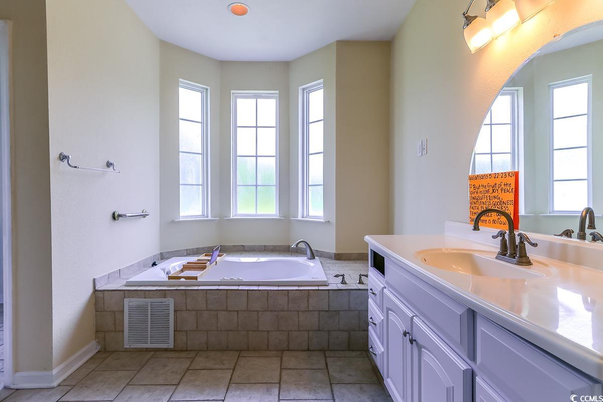 2191 Jasmine Road Loris, SC 29569 - Photo 16 of 40 Full bath featuring vanity, a garden tub, baseboards, and tile patterned floors
